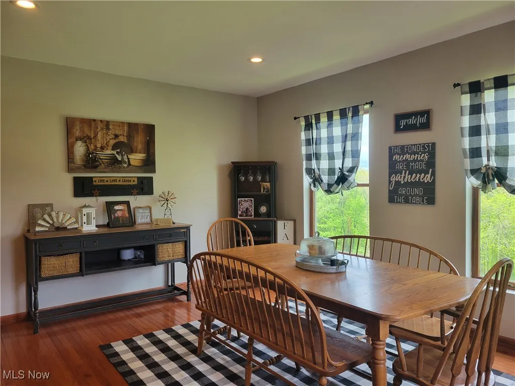 Dining area with recessed lighting, wood-type flooring, and baseboards