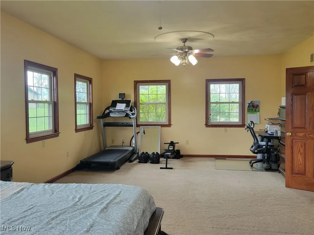 Bedroom with carpet, baseboards, and ceiling fan