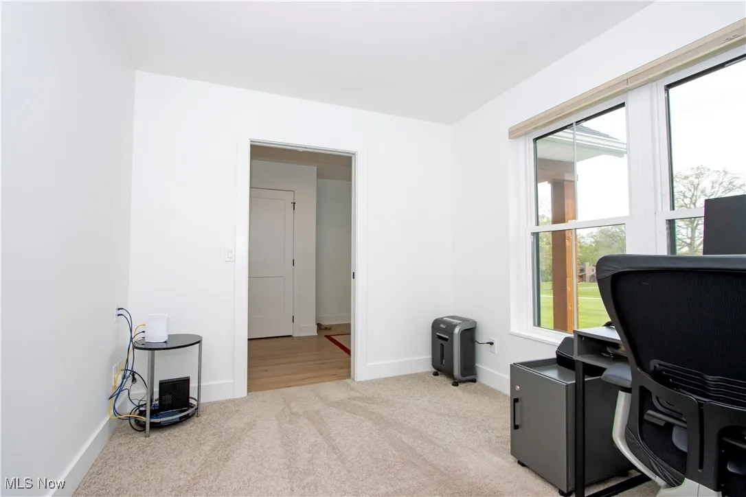 Carpeted office featuring baseboards