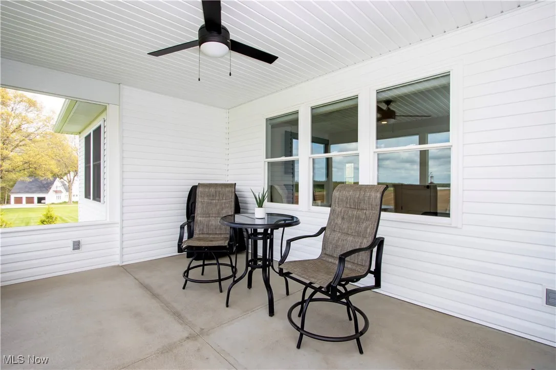 View of patio / screended porch with a ceiling fan