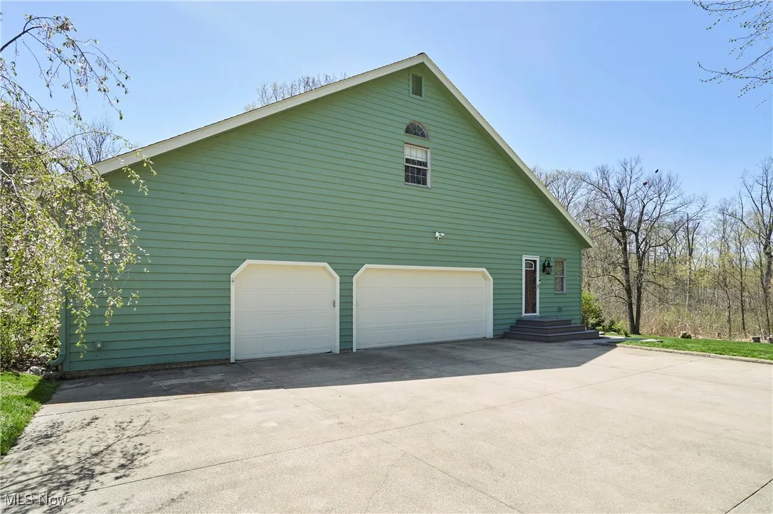 View of side of home featuring a garage