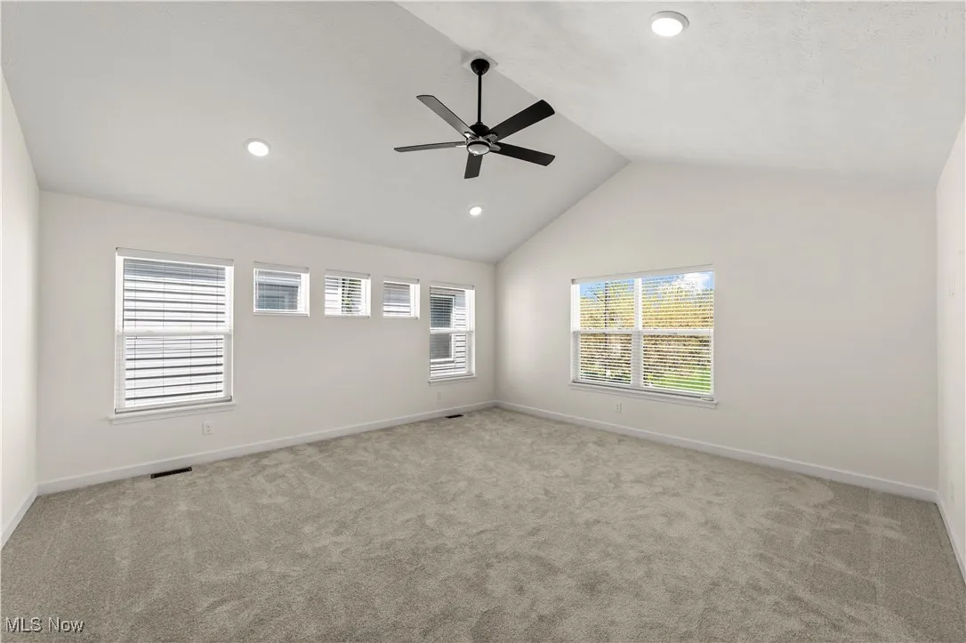 Bedroom with ceiling fan, carpet, vaulted ceiling, baseboards, and recessed lighting