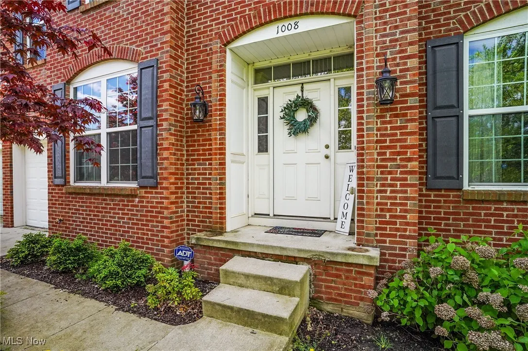 Doorway to property with brick siding