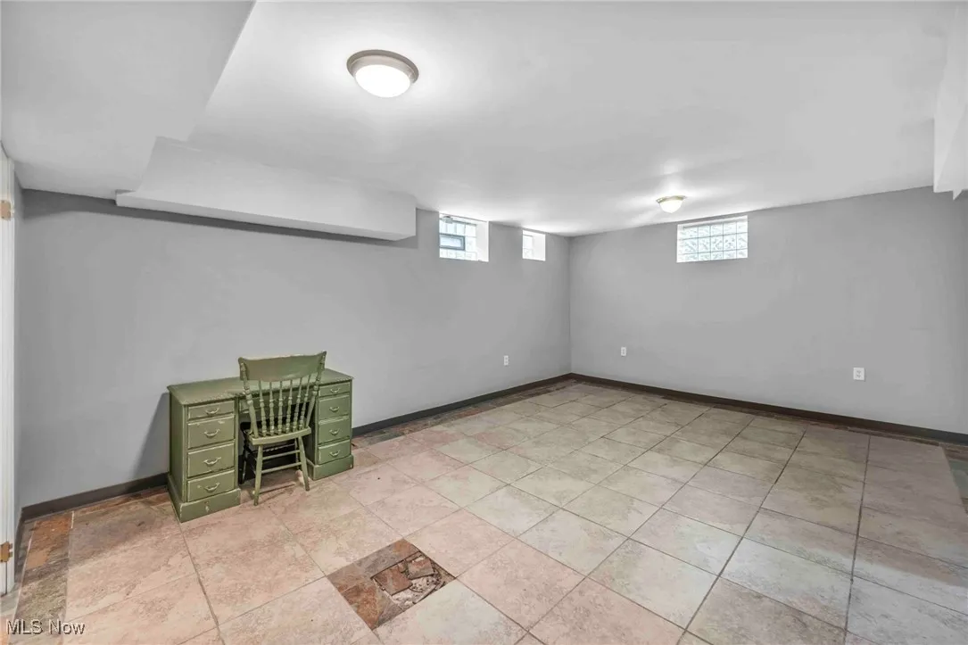 Basement with plenty of natural light and baseboards
