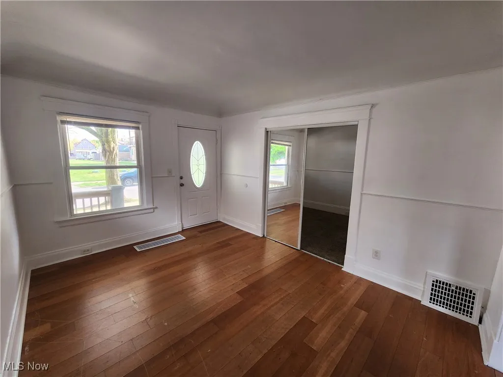 Entryway featuring dark wood finished floors and baseboards