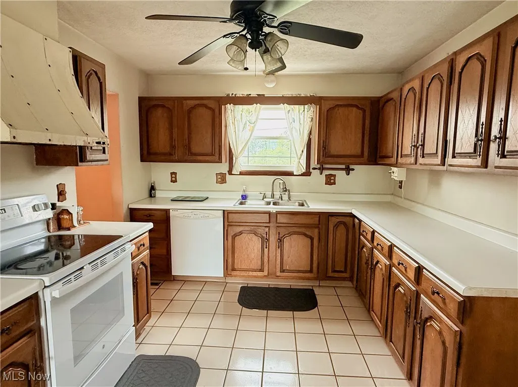 Kitchen with ceiling fan and brown cabinetry