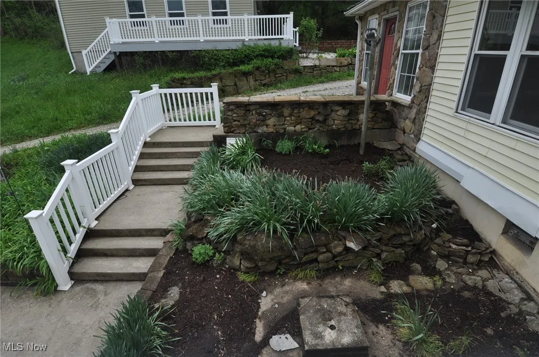 View of yard featuring stairway and landscaping of main house