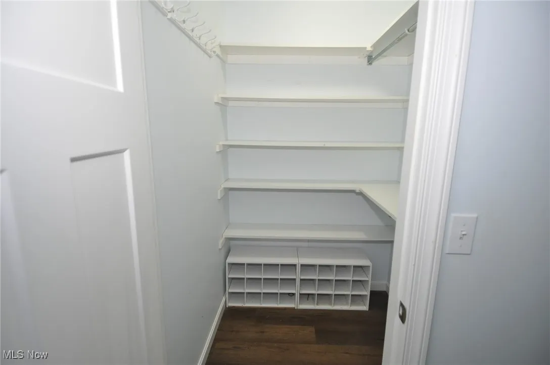 Bungalow spacious bedroom closet with wood finished floors