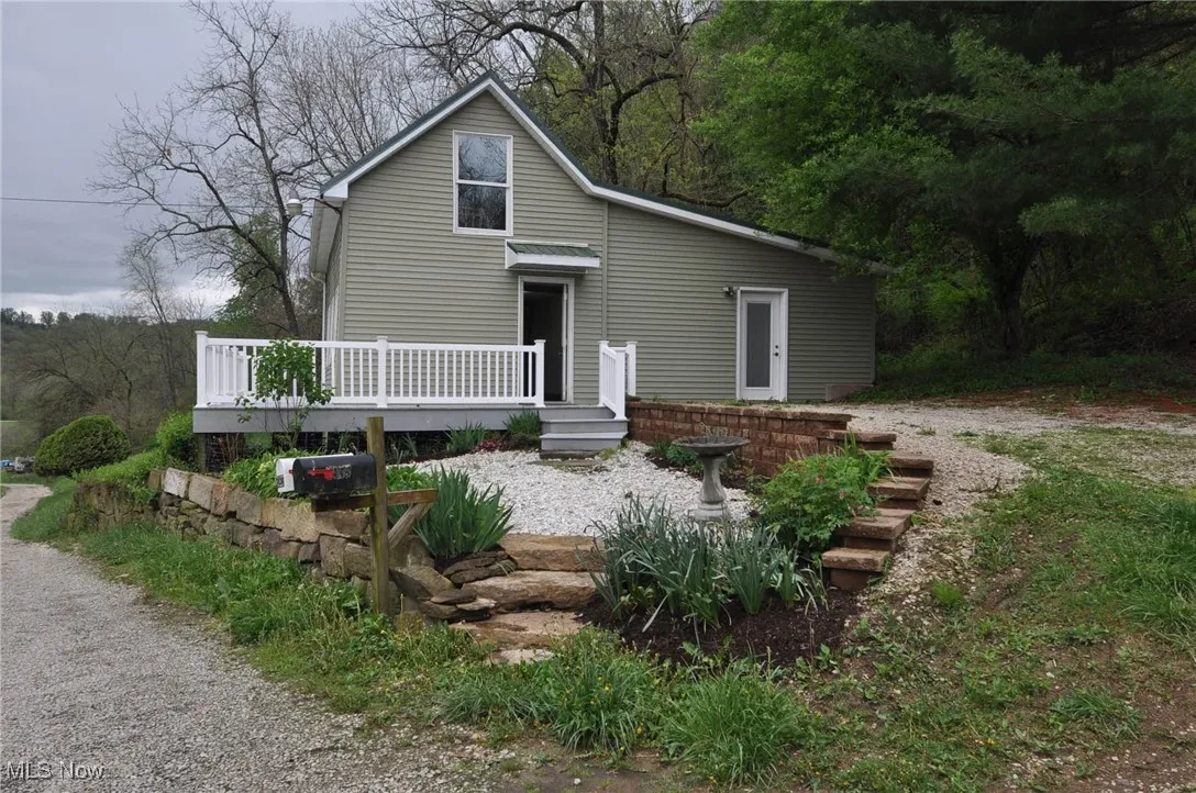 Bungalow side view of home with a wooden deck