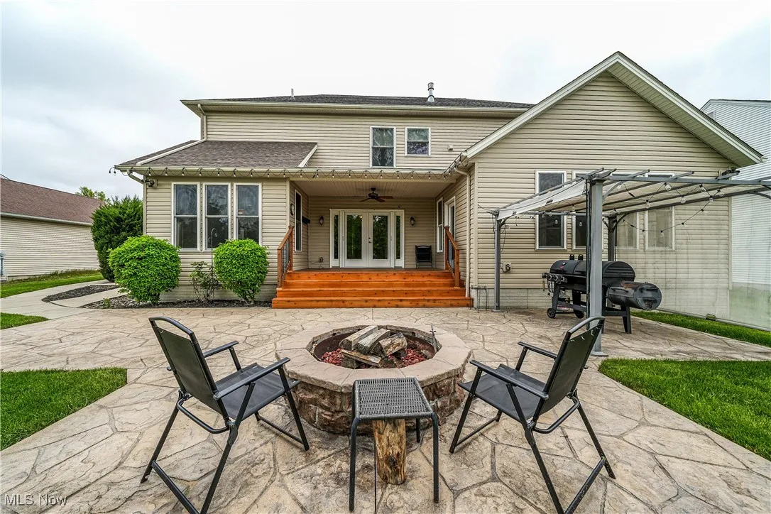 Back of house featuring an outdoor fire pit, french doors, a patio, a ceiling fan, and a pergola