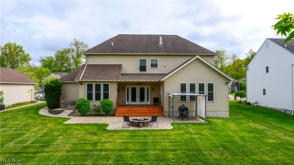 Rear view of house with a fire pit, french doors, a patio, and a yard