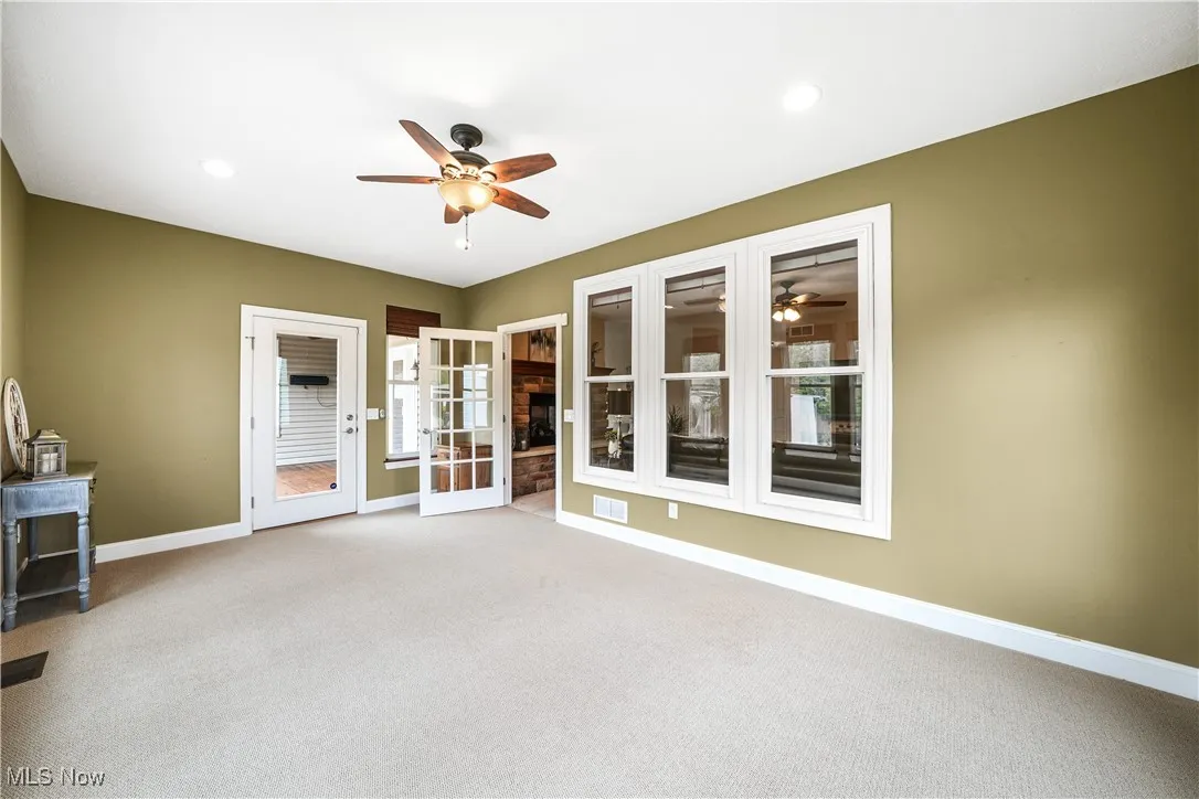 Spare room with ceiling fan, carpet floors, baseboards, and recessed lighting
