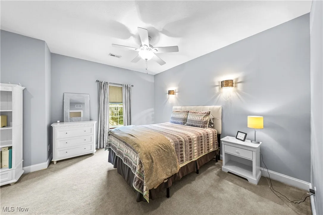 Carpeted bedroom with baseboards and ceiling fan
