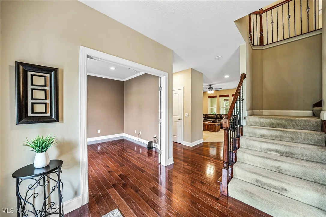 Entrance foyer with stairs, baseboards, hardwood / wood-style floors, a ceiling fan, and recessed lighting