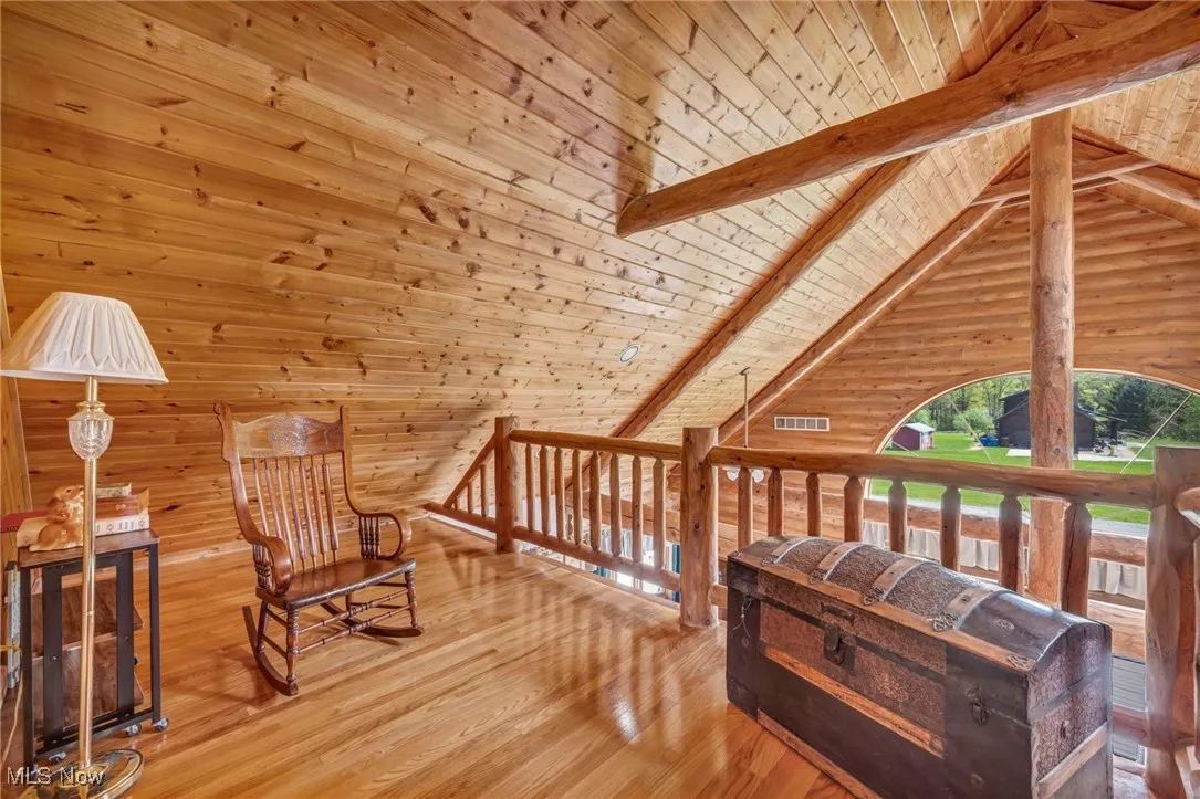 Sitting room featuring wood ceiling, hardwood / wood-style flooring, and wood walls
