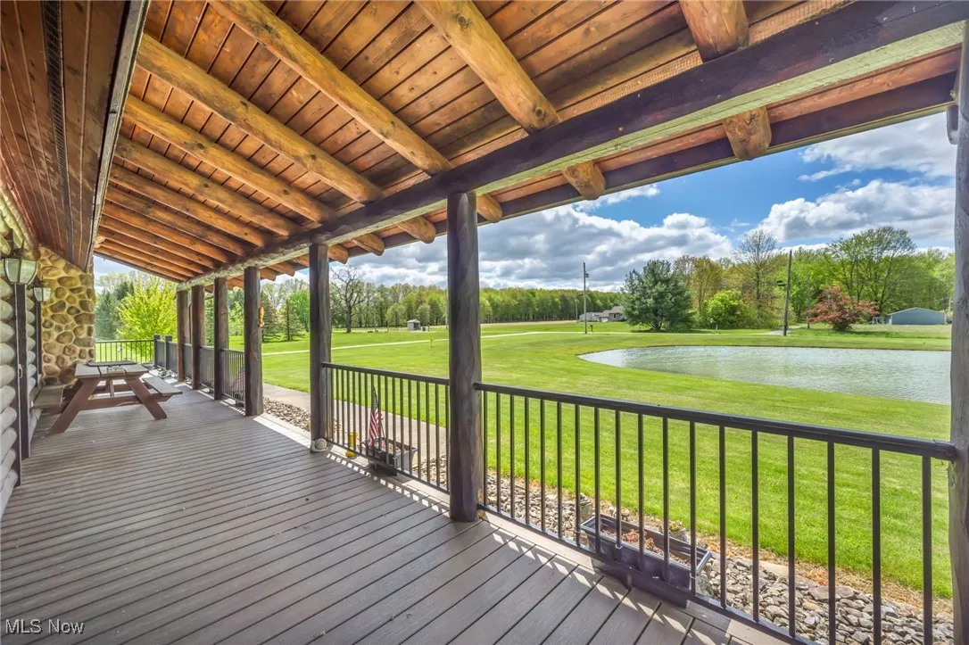 Front Porch Wooden terrace with view of scattered trees and a yard