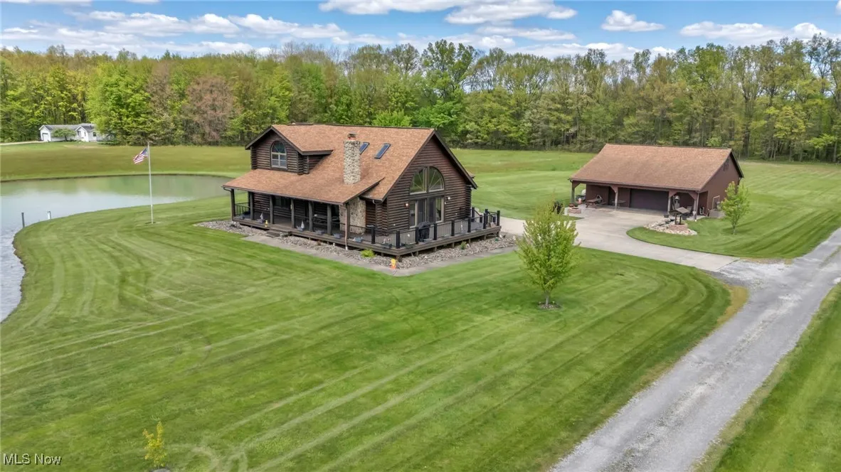 Drone / aerial view of house and pond