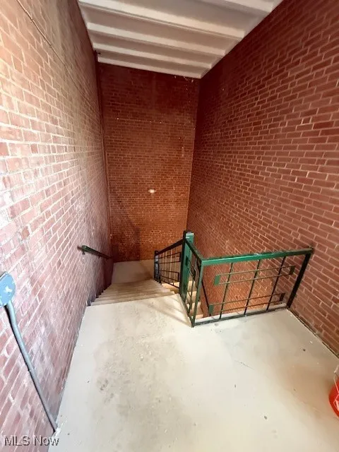 Stairs with brick wall and concrete flooring