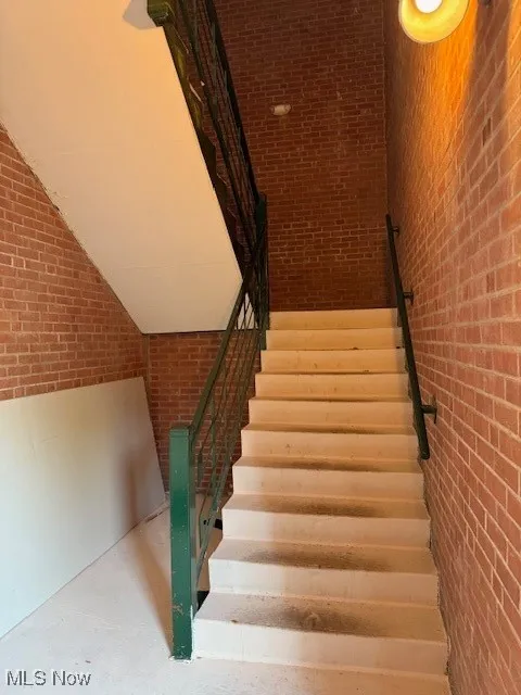 Stairway with brick wall and concrete floors