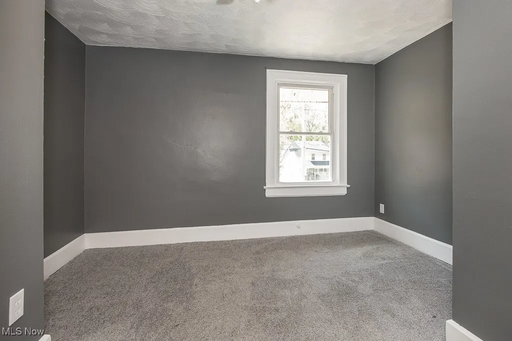 Carpeted bedroom with baseboards