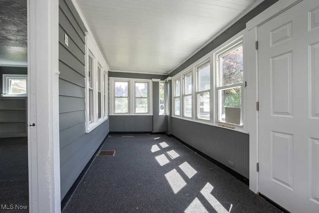 Unfurnished front porch with carpet