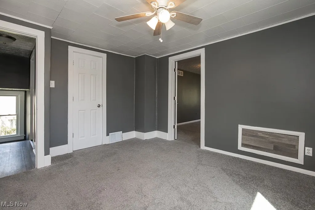 Unfurnished bedroom featuring carpet, baseboards, and ceiling fan