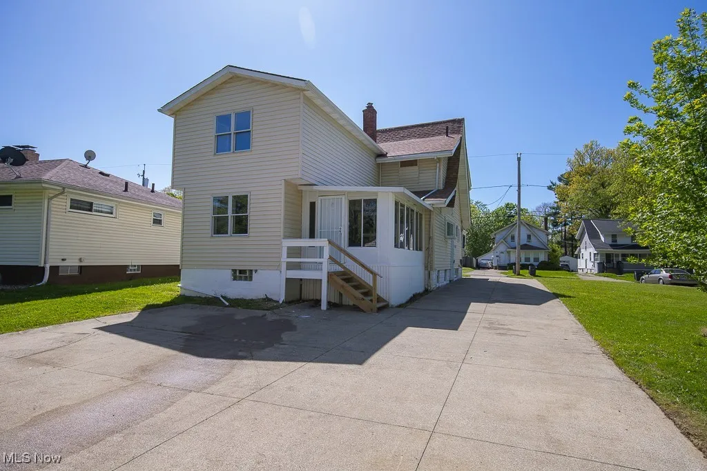 Back of property featuring a yard and a chimney