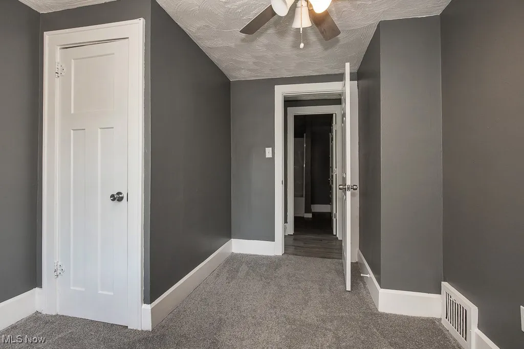 Bedroom featuring carpet and baseboards