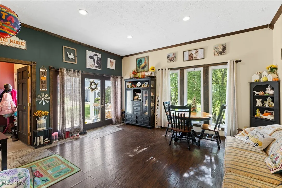 Dining room with ornamental molding, french doors, healthy amount of natural light, recessed lighting, and hardwood / wood-style floors