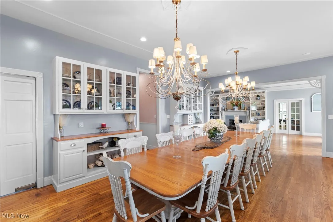 Dining space featuring a chandelier, light wood-style flooring, baseboards, and recessed lighting