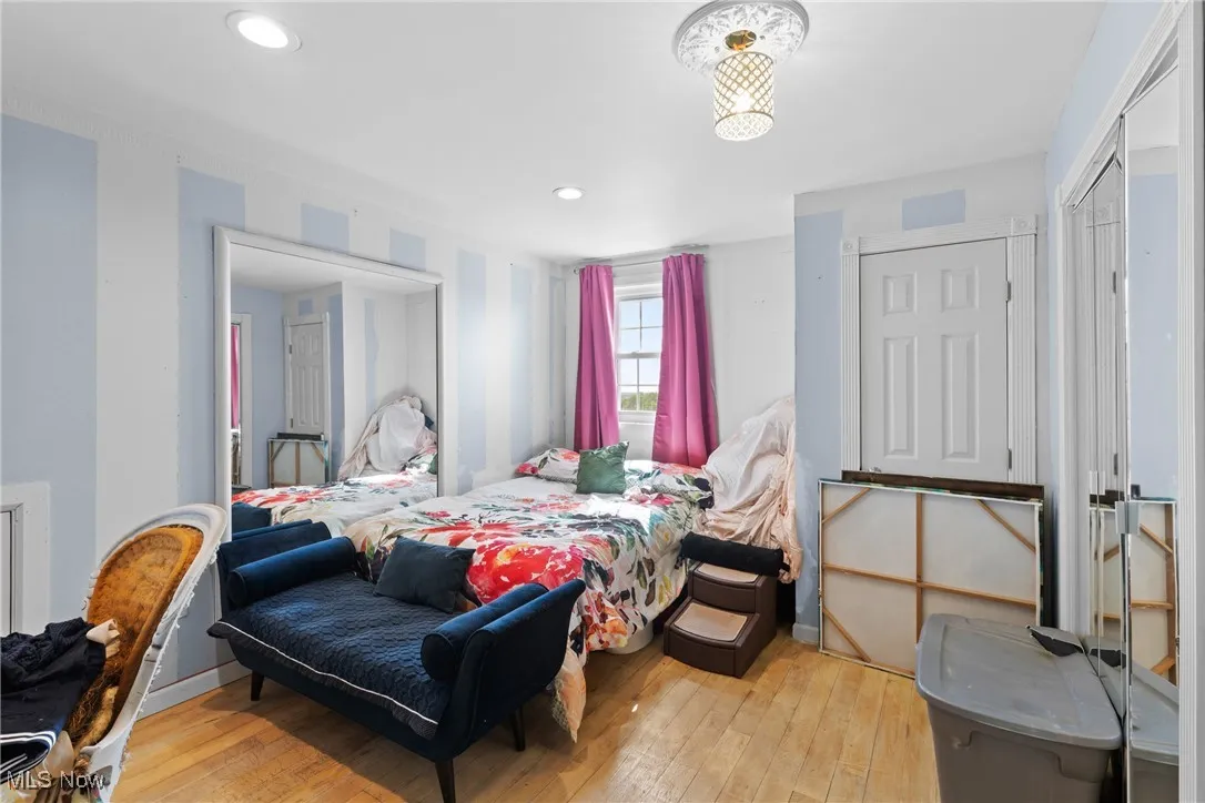 Bedroom with light wood finished floors and recessed lighting