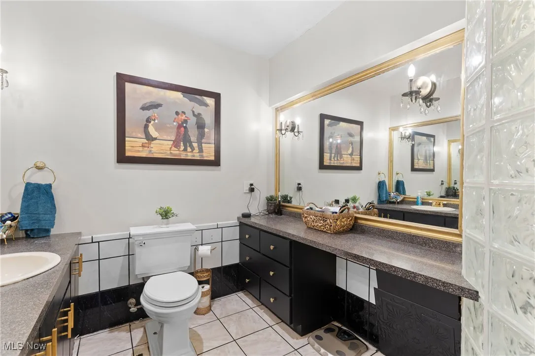Bathroom with tile patterned floors, vanity, and toilet