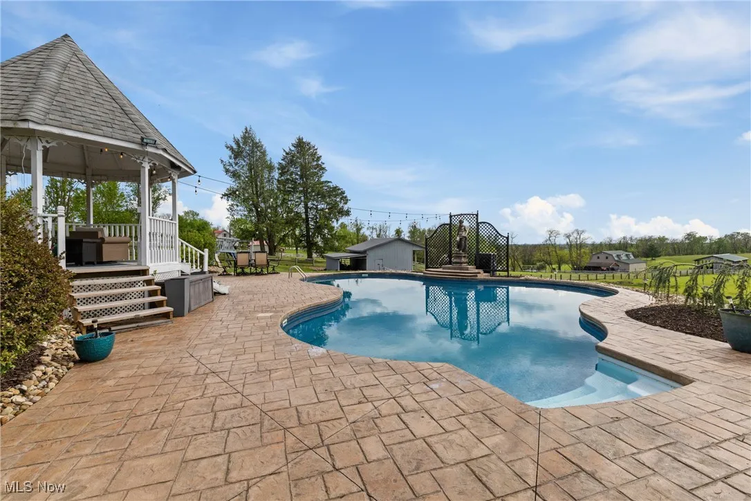 Swimming pool with a gazebo and a patio