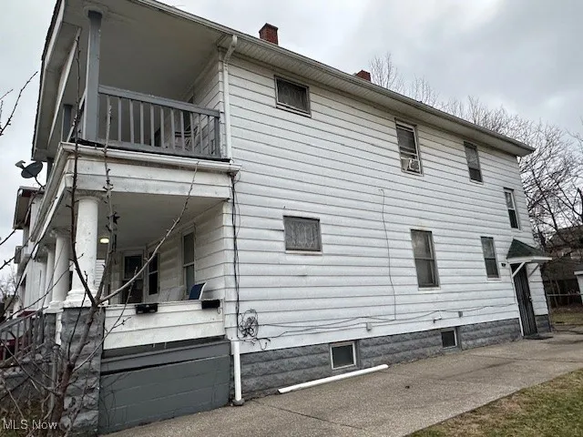 View of home's exterior featuring a chimney and a balcony