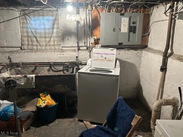 Washroom featuring washer / dryer and electric panel