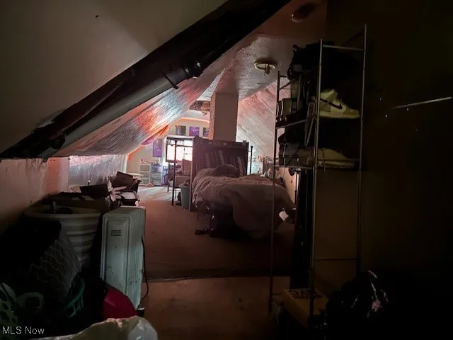 Bedroom featuring vaulted ceiling