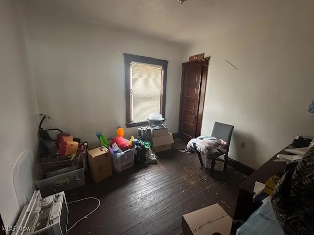 Bedroom with hardwood / wood-style flooring