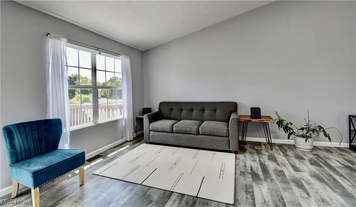 Sitting room featuring baseboards and wood finished floors
