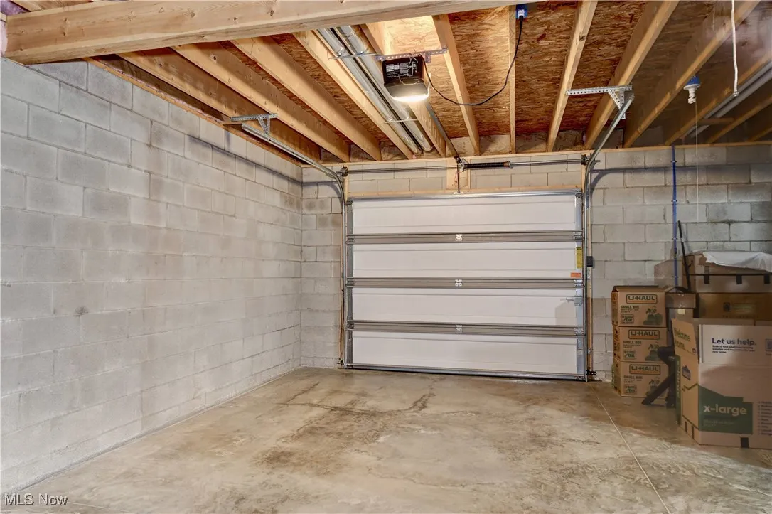 Garage featuring concrete block wall