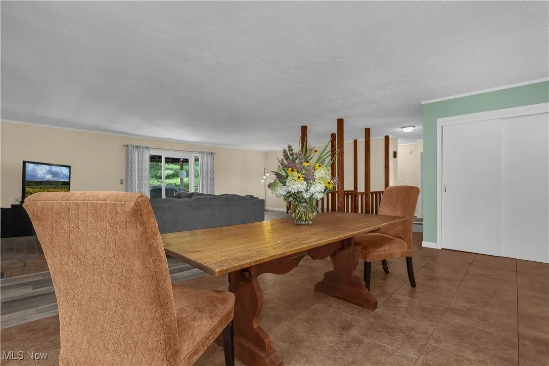 Tiled dining space featuring a textured ceiling
