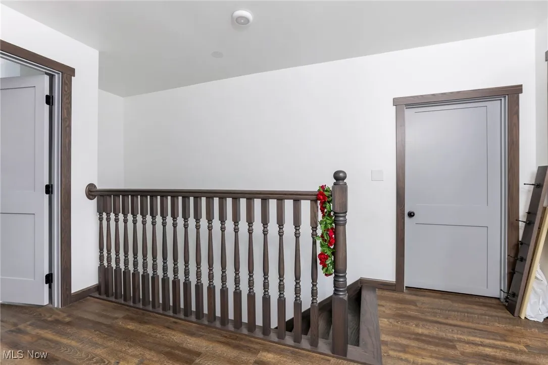 Hallway featuring wood finished floors and baseboards
