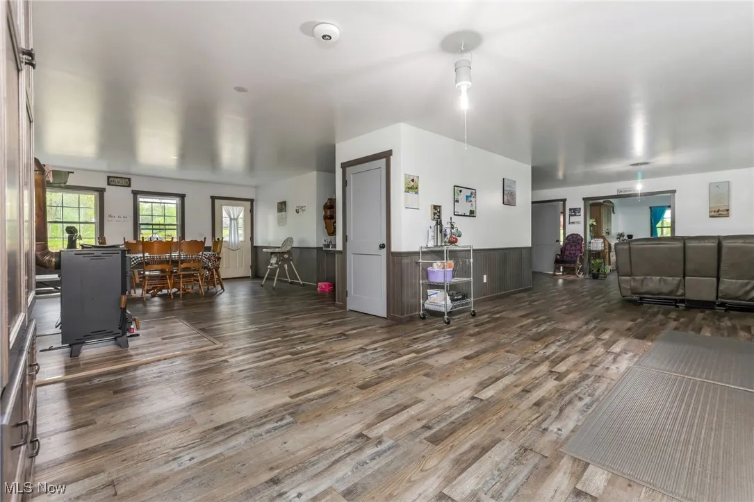 Miscellaneous room featuring wood finished floors and a wainscoted wall