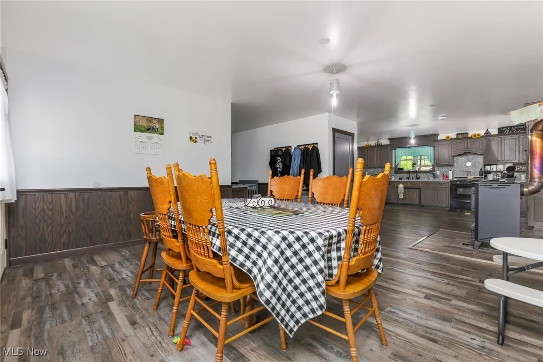Dining room featuring dark wood-style flooring