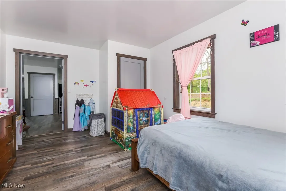 Bedroom featuring dark wood-style flooring