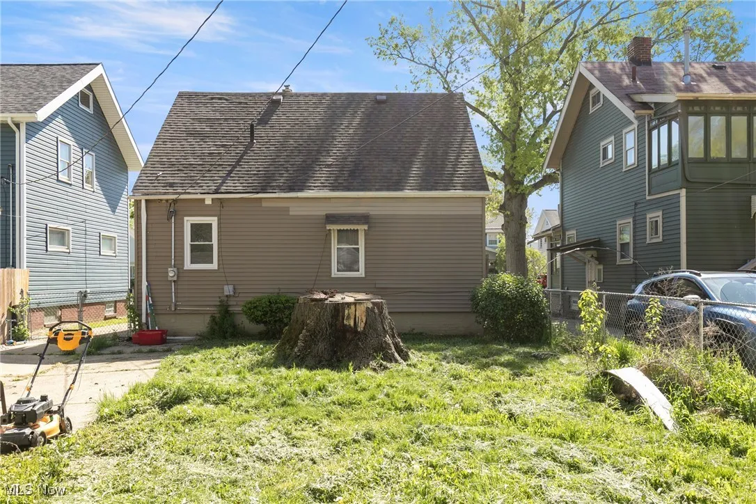 Rear view of property featuring roof with shingles