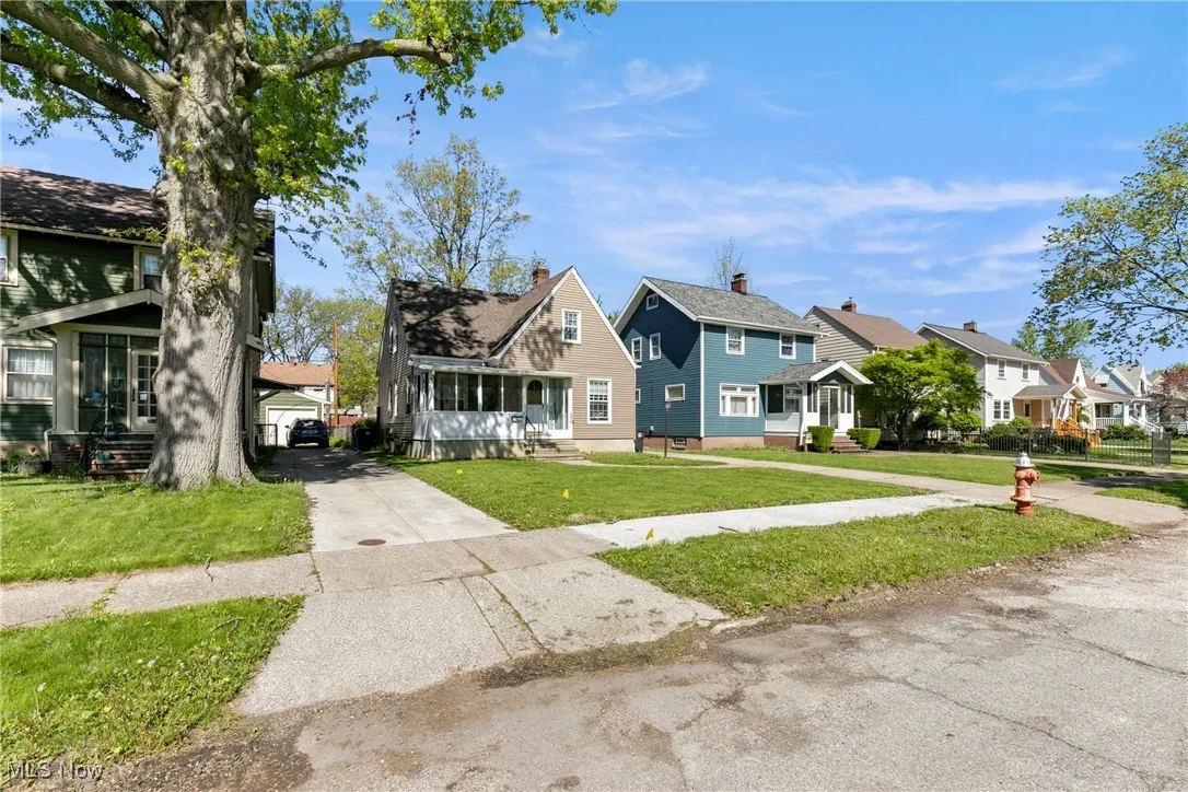 View of front of house with a residential view, driveway, and a front yard
