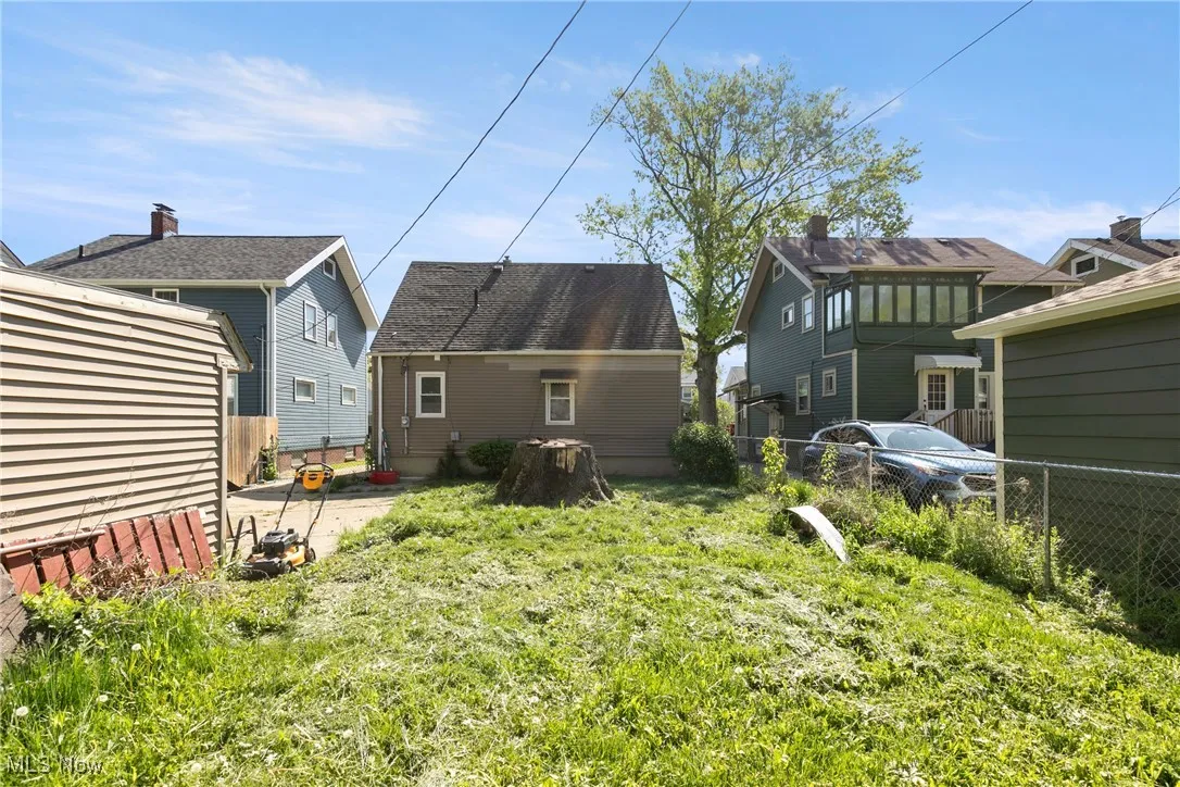 Back of property featuring fence and a patio area