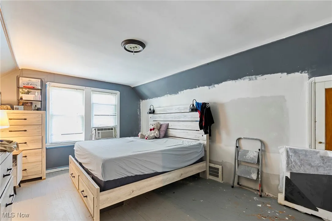 Bedroom featuring lofted ceiling and light wood finished floors
