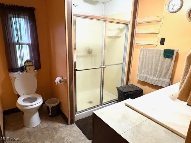 Bathroom with vanity and a shower stall