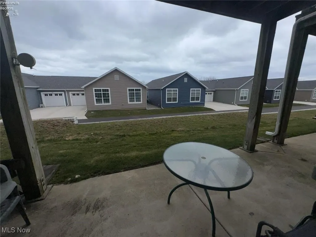 View of patio with driveway and a garage